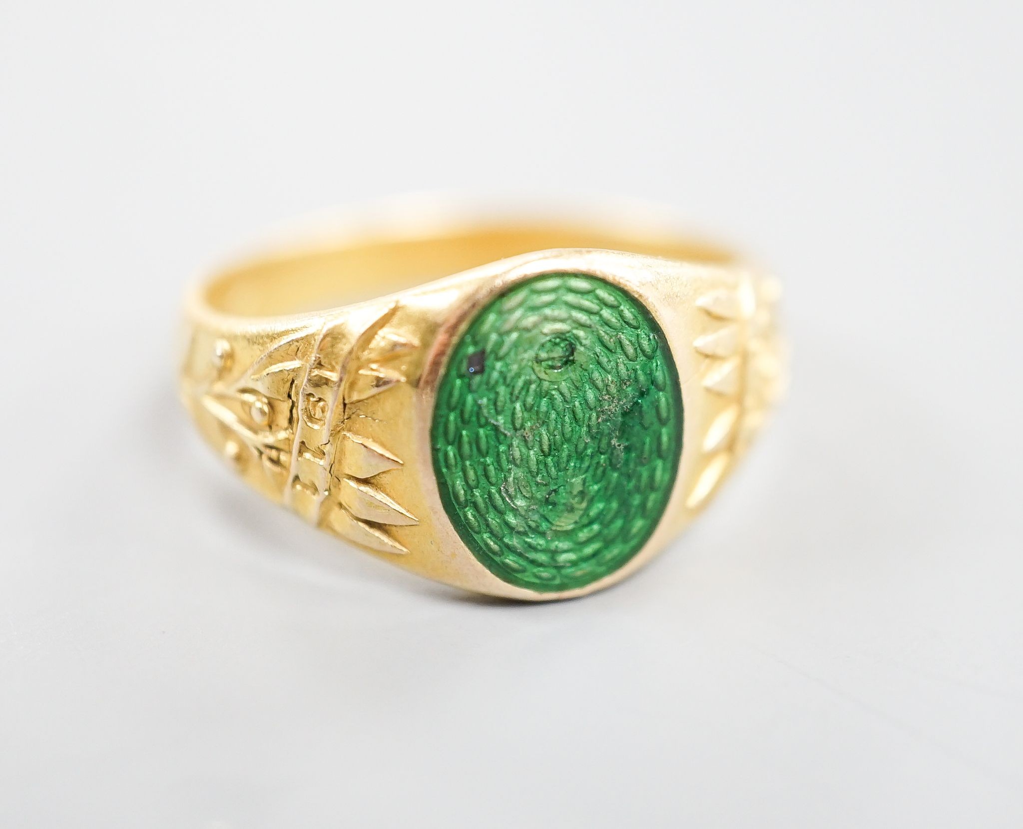An early 20th century Austro-Hungarian (Vienna) 580/1000 yellow metal and green enamel signet ring, depicting the bust of a gentleman to sinister, size Q/R, gross 6.7 grams.